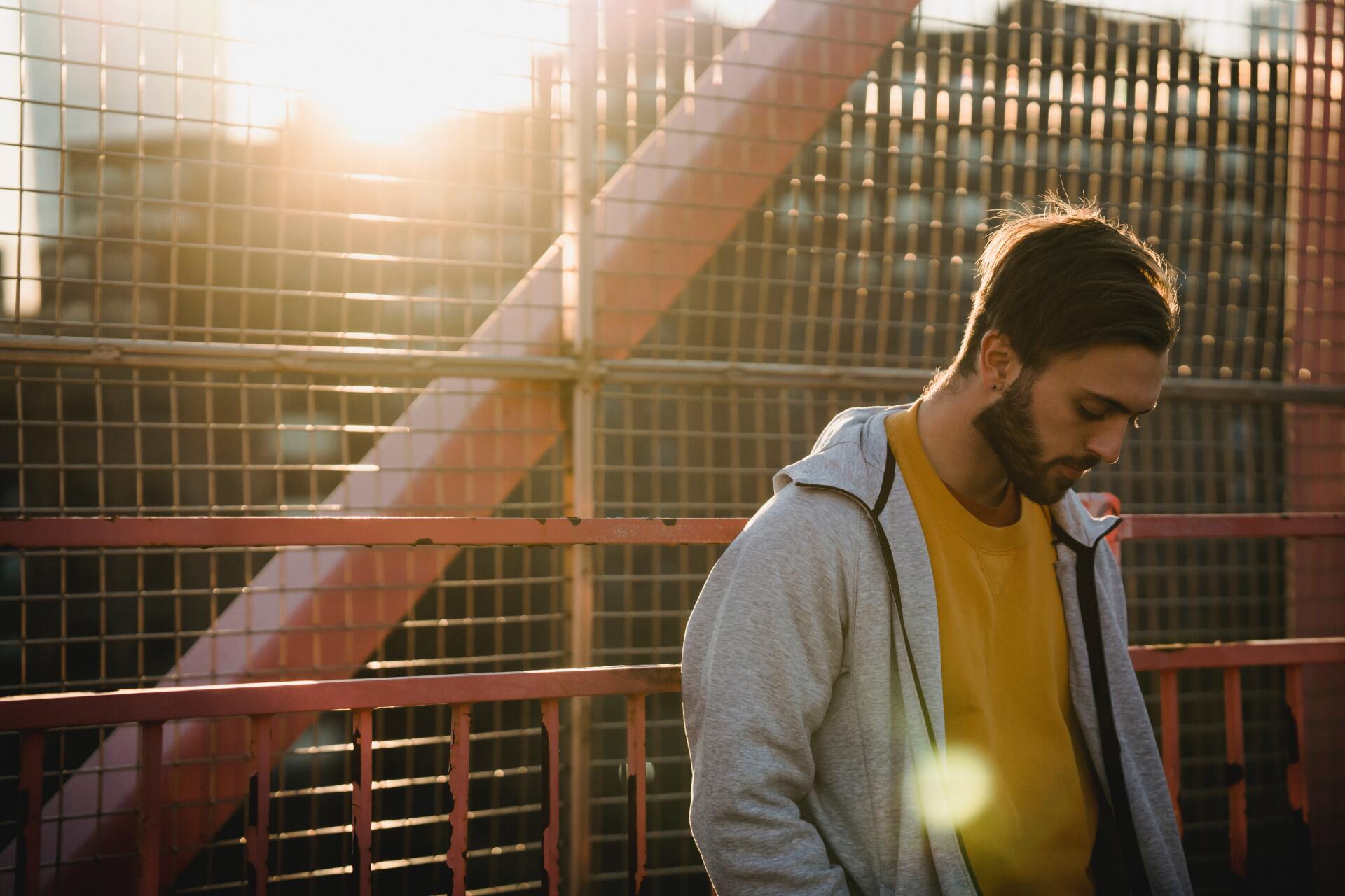 Man leaning on a fence